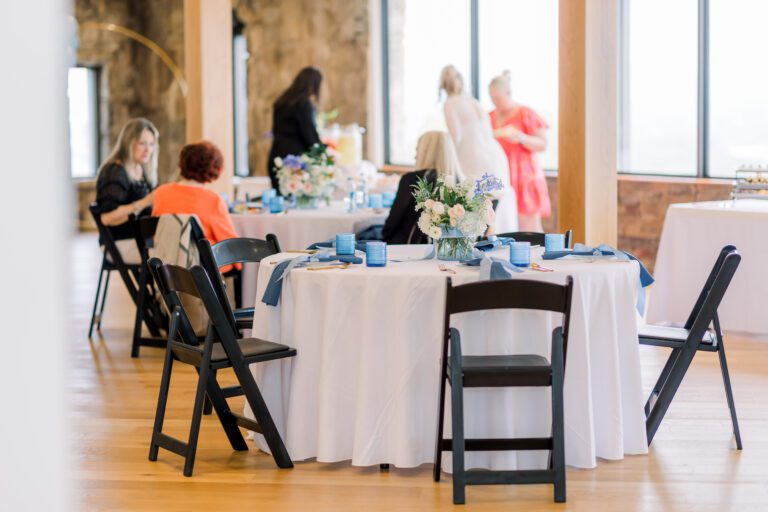 Women sitting at tables decorated for a bridal shower at Skyline Loft
