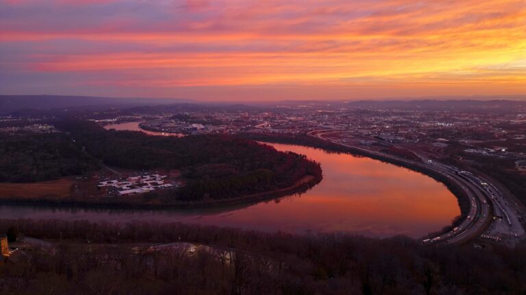 Sunrise featuring a pink and orange sky reflecting on the Tennessee River.