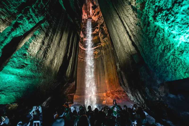 A group of people touring Ruby Falls Cave with the waterfall in the background. 